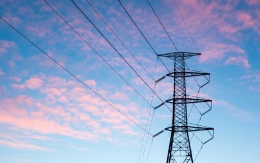 pylons against a blue sky with pink clouds